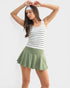 Woman wearing a striped tank top and green skirt on a white background