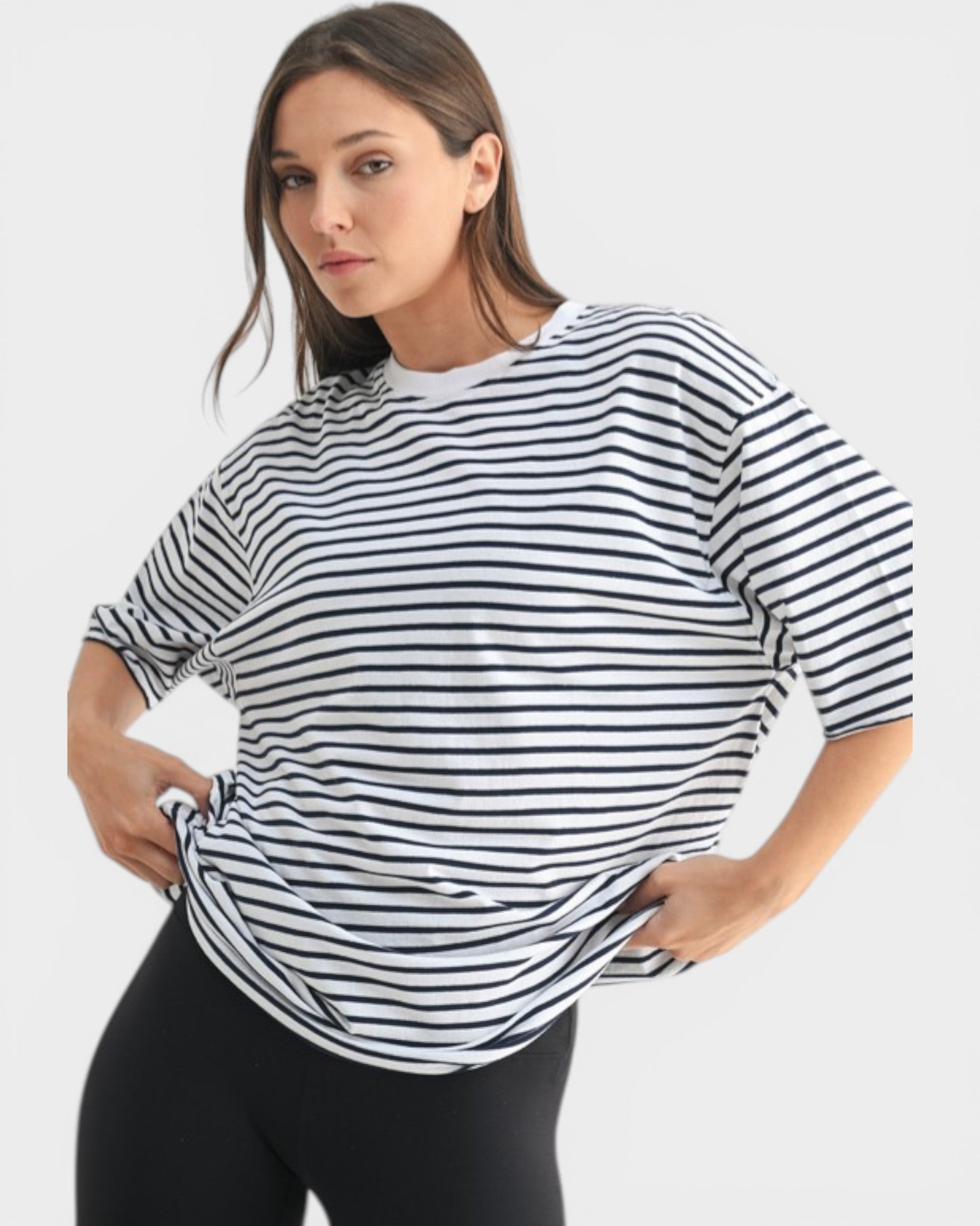 Woman wearing a black and white striped shirt on a white background