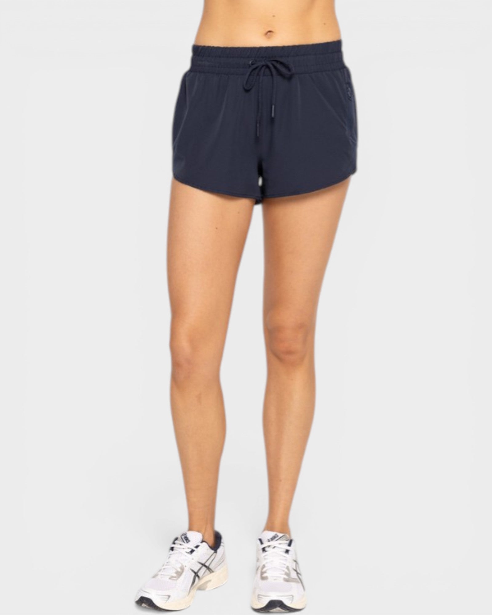 Person wearing navy athletic shorts on a white background