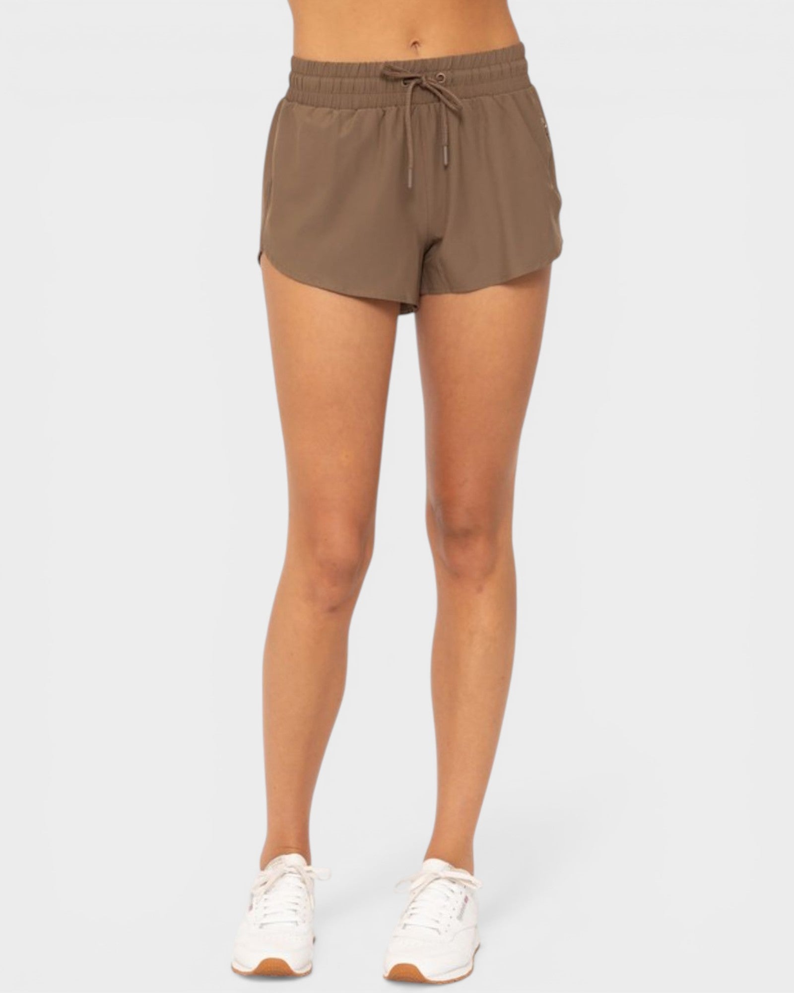 Person wearing brown shorts on a white background