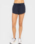 Person wearing navy athletic shorts on a white background
