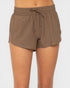 Brown shorts worn by a person on a white background