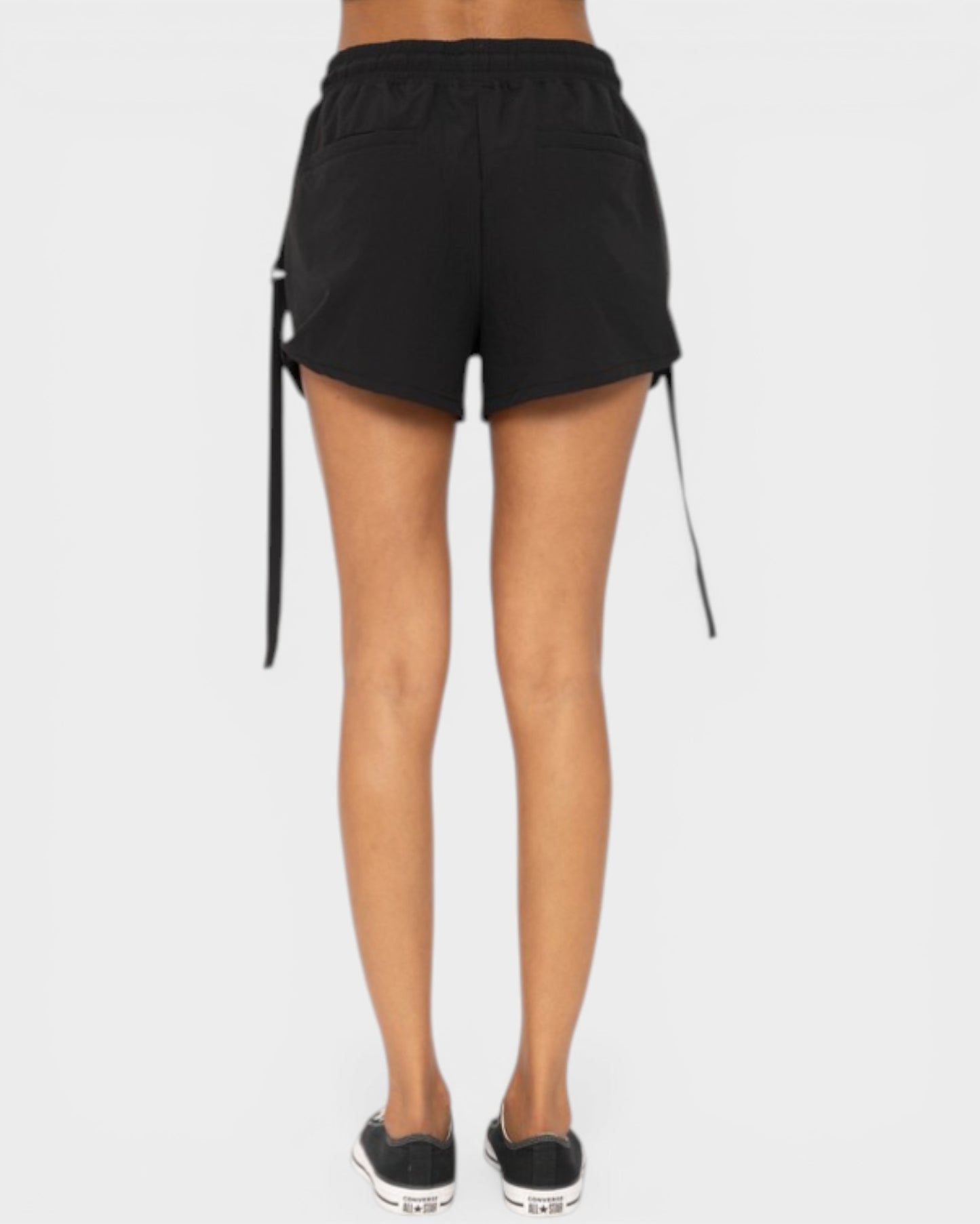 Black shorts with drawstrings on a white background