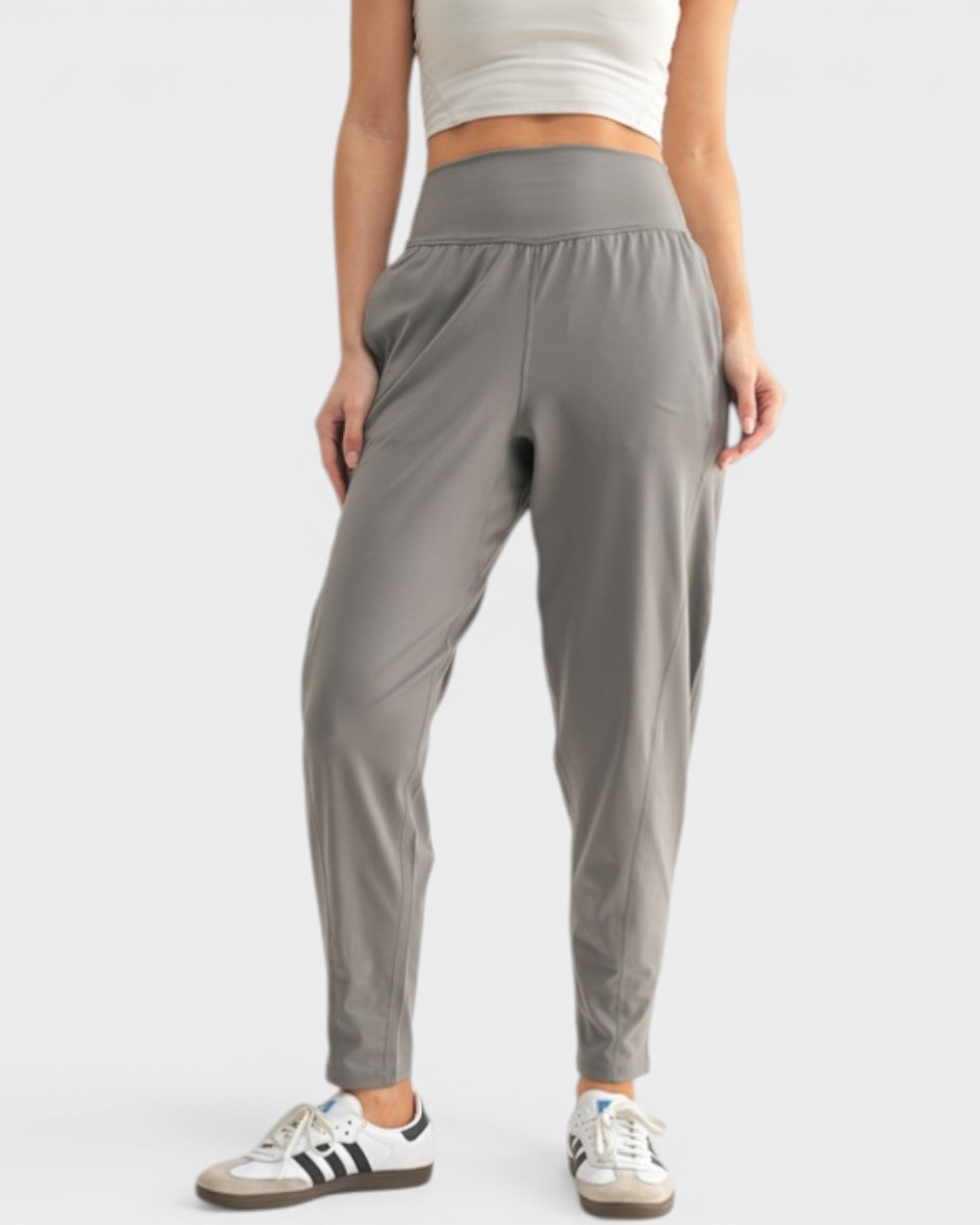 Person wearing gray sweatpants on a white background