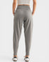 Person wearing gray high-waisted pants on a white background