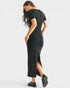 Woman wearing a black dress with a slit on a white background