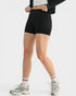 Person wearing black high-waisted shorts on a white background