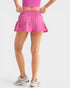 Person wearing a pink skirt on a plain background