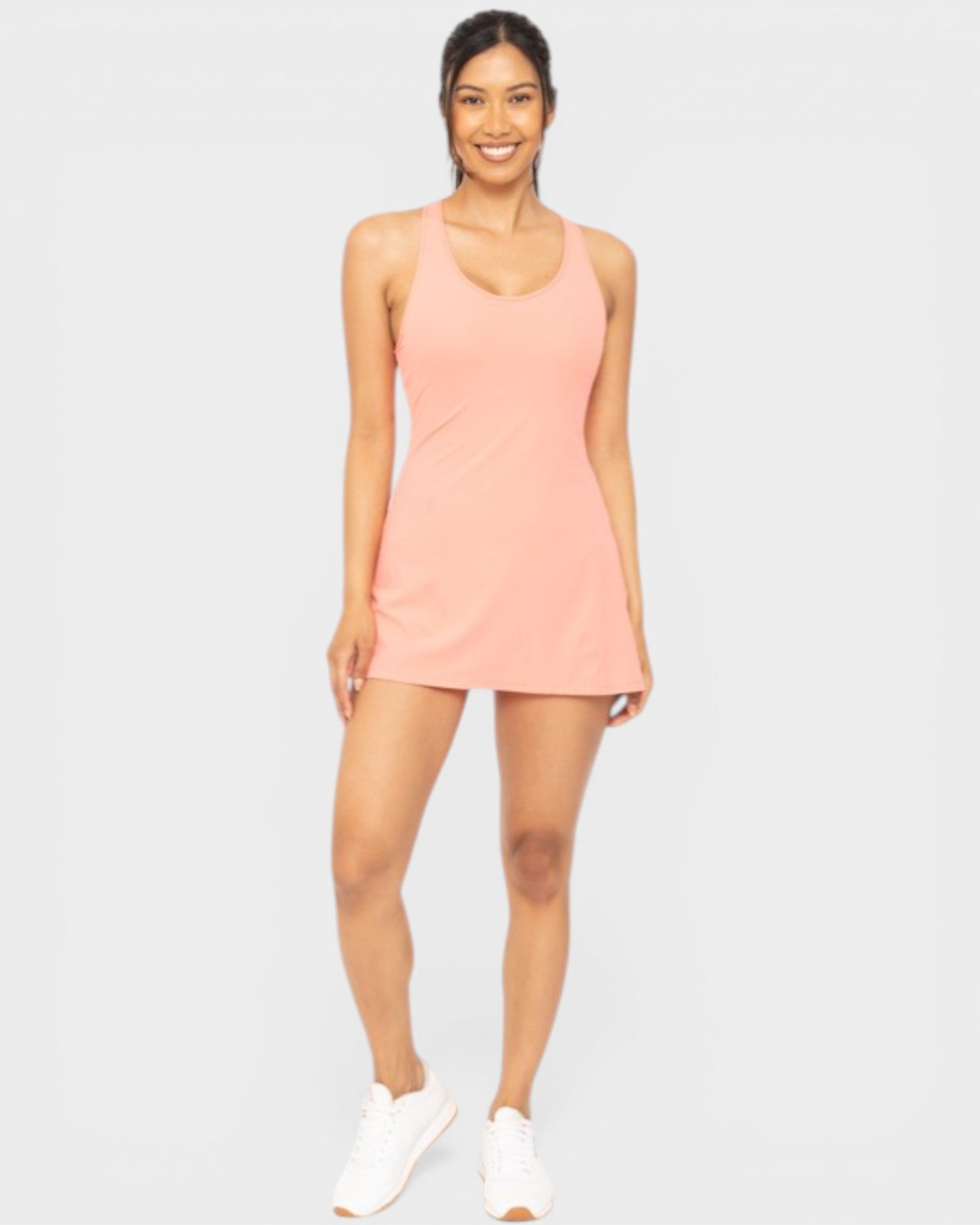 Woman wearing a pink dress on a white background