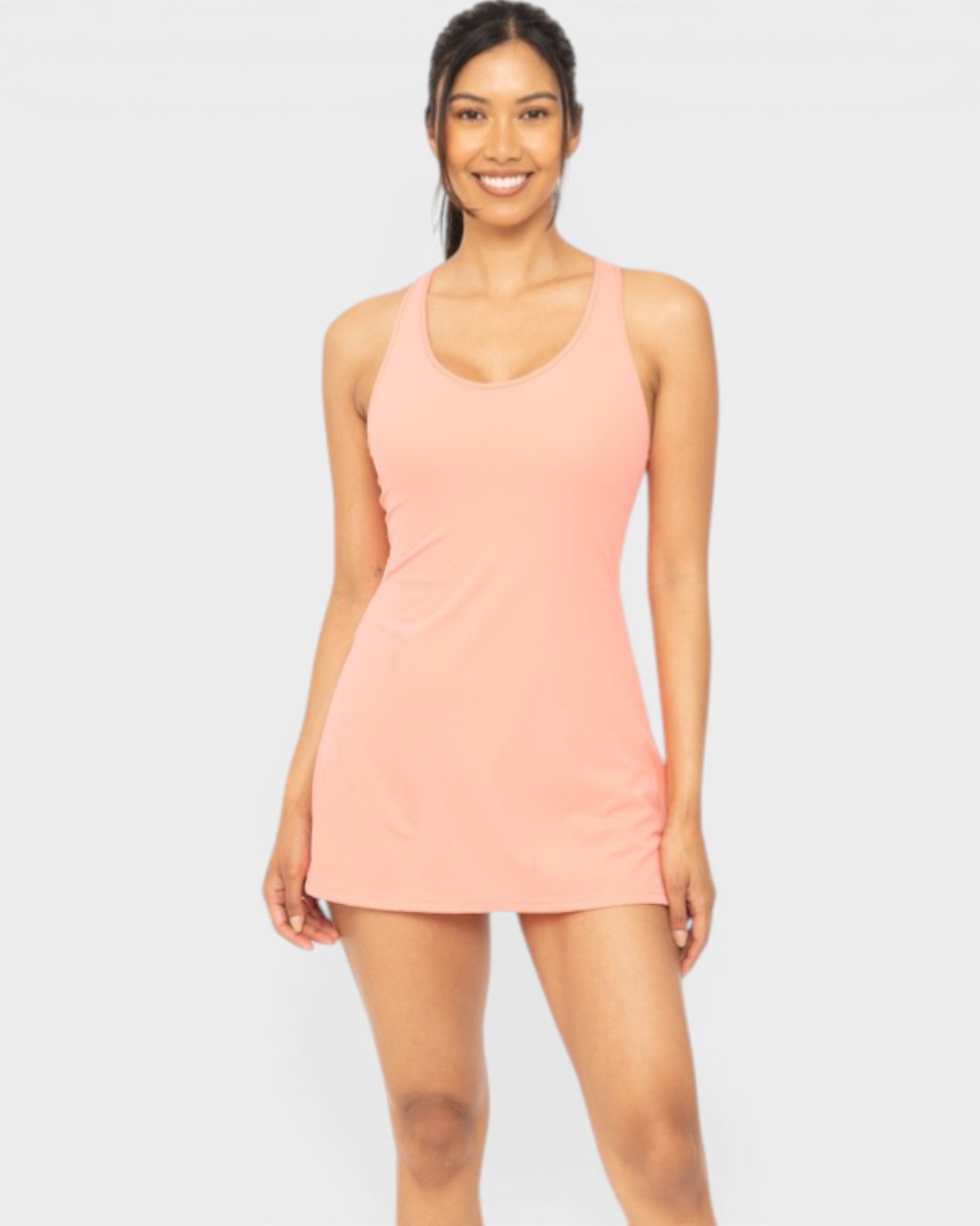 Woman wearing a pink dress on a white background
