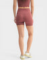 Person wearing a matching athletic outfit with shorts and top on a white background