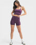 Woman wearing a purple athletic outfit on a white background