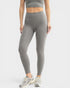 Person wearing gray leggings and a matching top on a white background