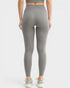 Person wearing gray leggings on a white background