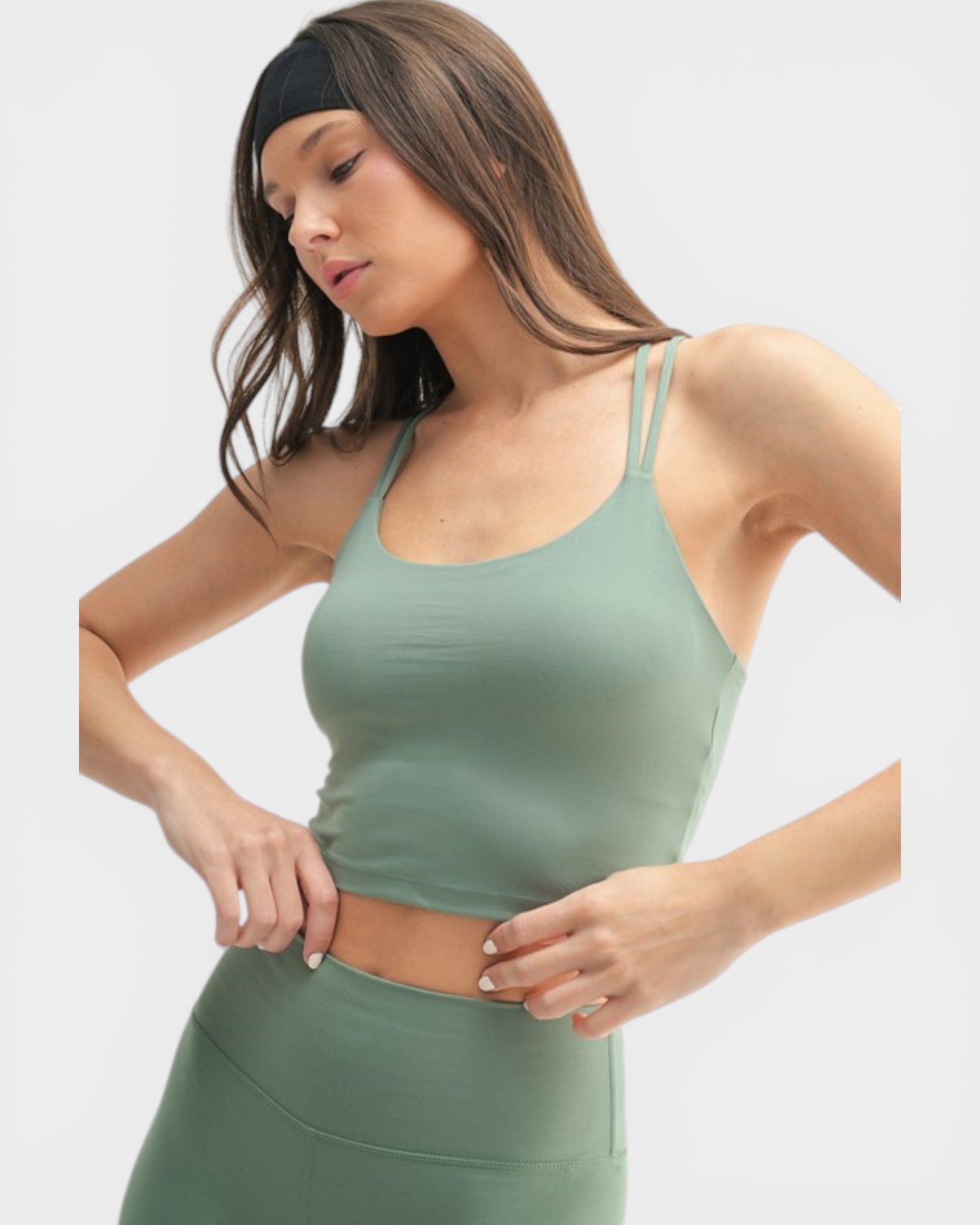 Woman wearing a green athletic outfit on a white background