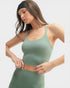 Woman wearing a green athletic outfit on a white background