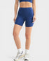 Person wearing blue athletic shorts on a white background