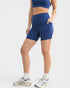 Person wearing blue athletic shorts on a white background