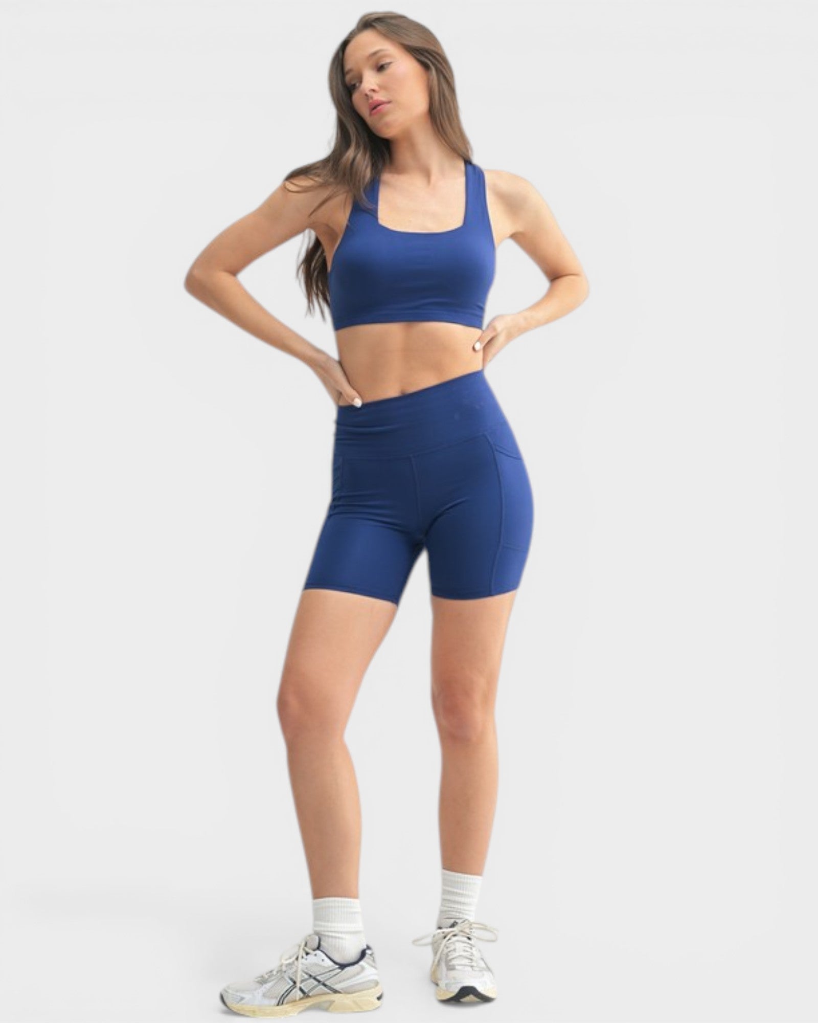 Woman wearing a blue athletic outfit on a white background
