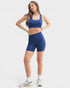 Woman wearing a blue athletic outfit on a white background