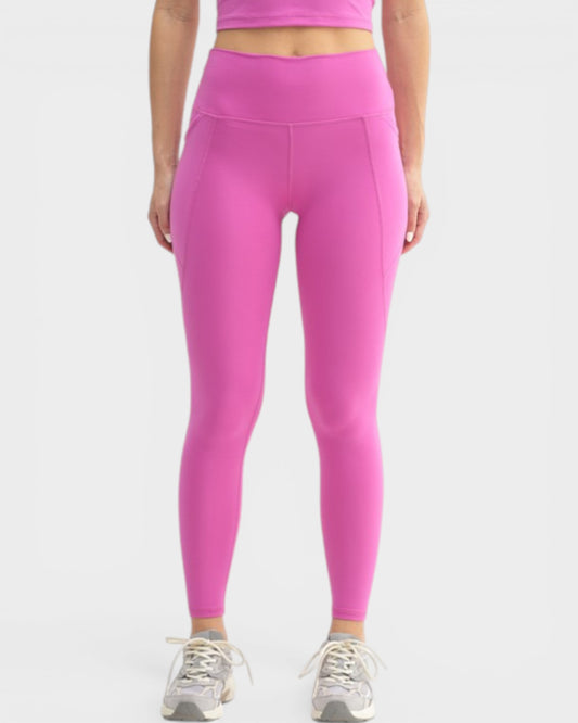 Person wearing bright pink leggings on a white background