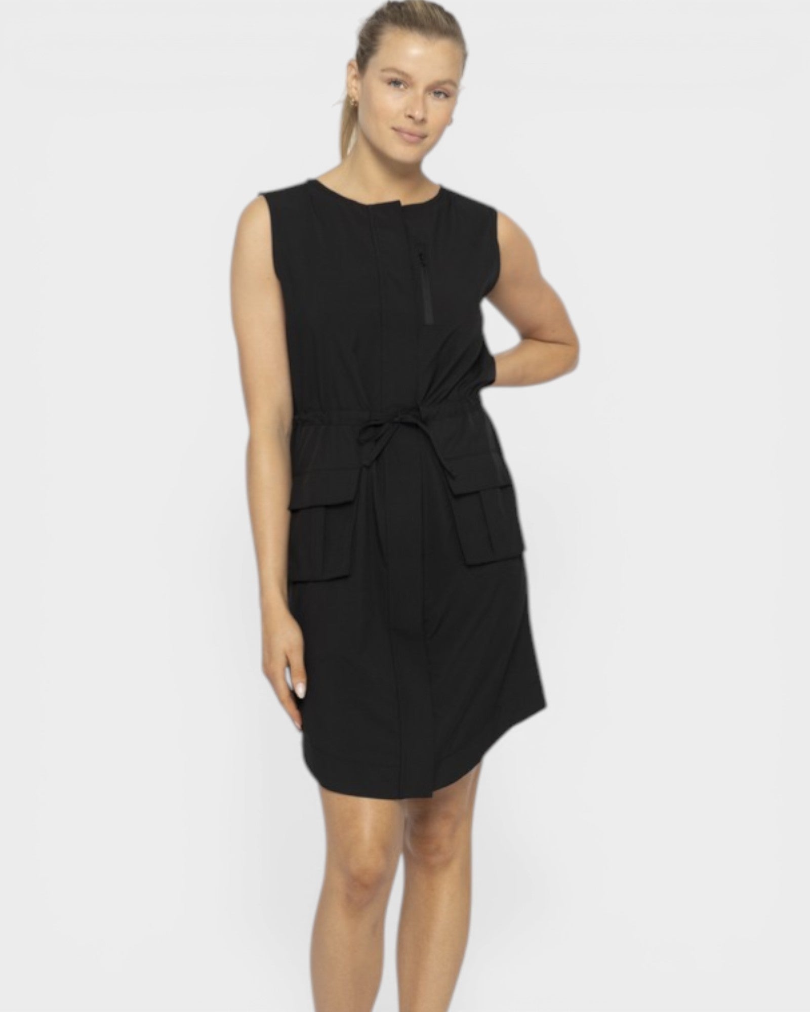 Woman wearing a black sleeveless dress on a white background