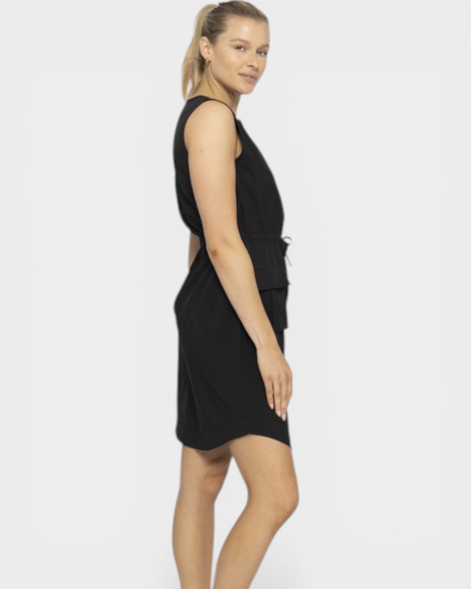 Woman wearing a black sleeveless dress on a white background