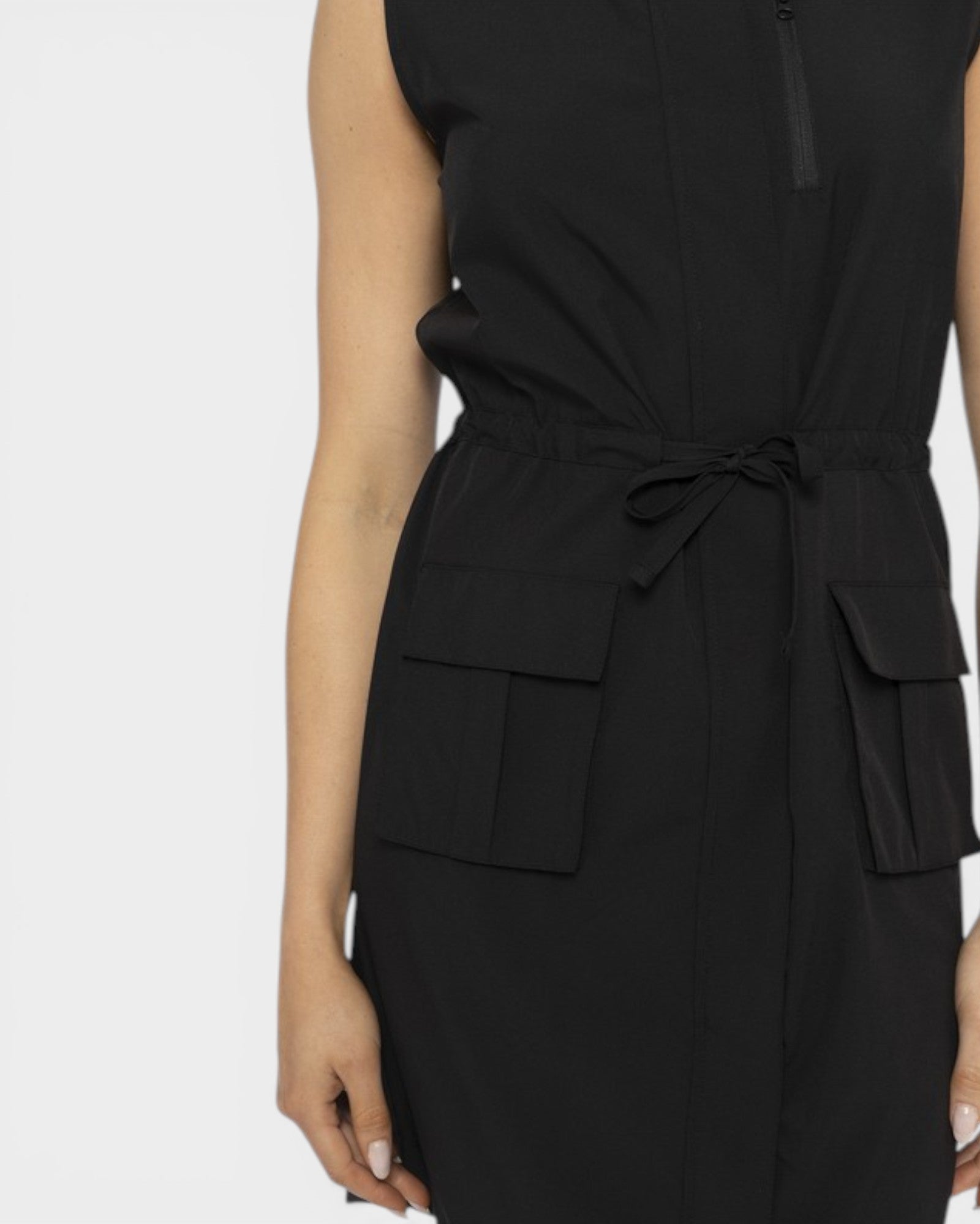 Black sleeveless dress with a tie waist on a white background