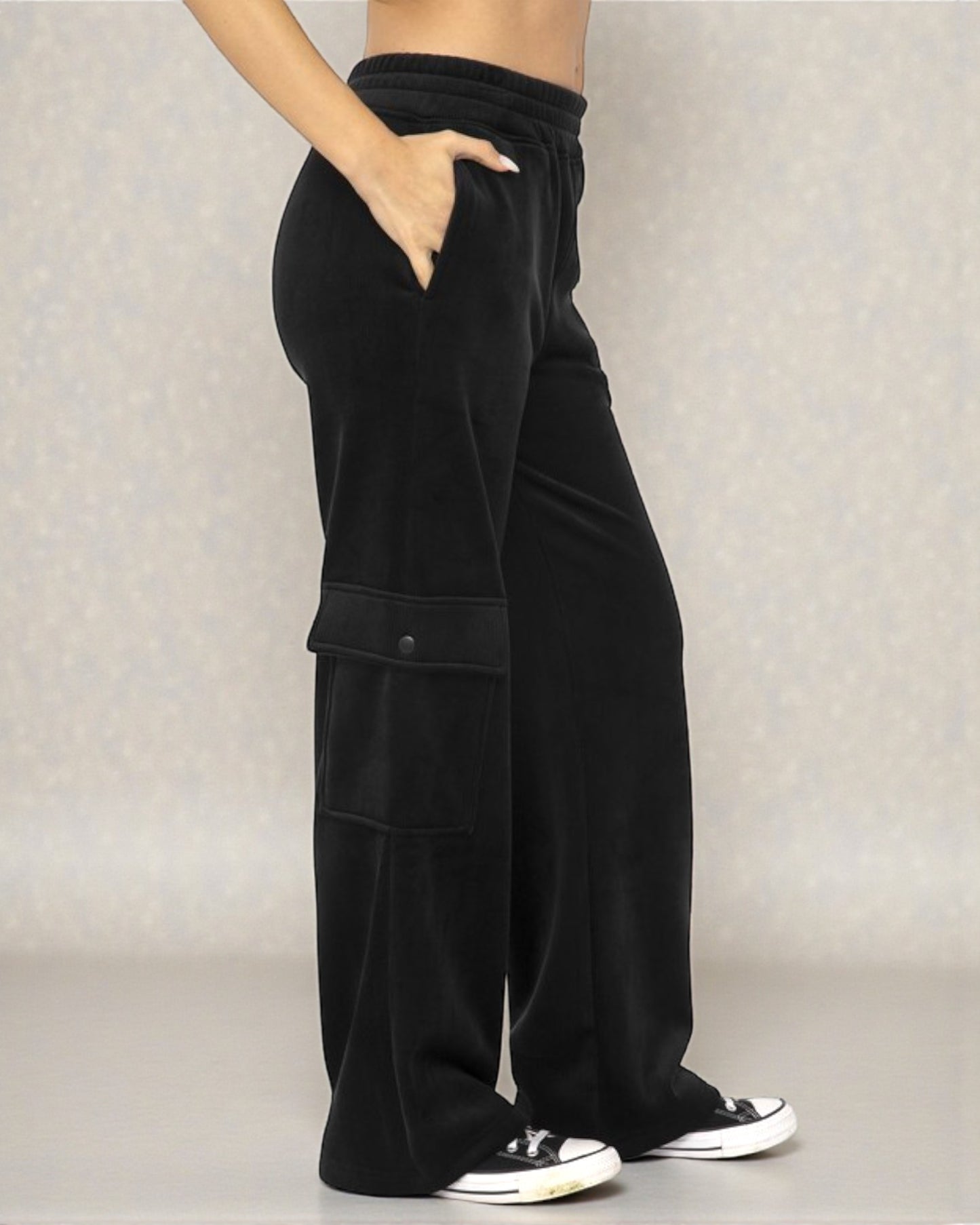 Black wide-leg pants worn by a person on a neutral background