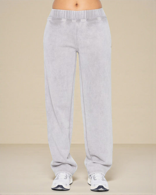 Gray sweatpants worn by a person on a beige background