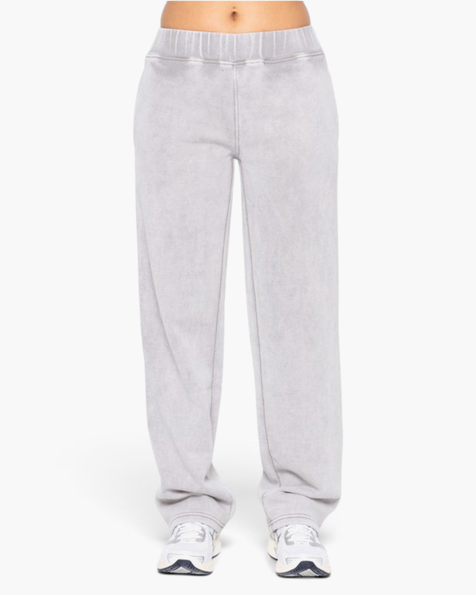 Light gray sweatpants worn by a model, shown from the waist down against a plain white background.
