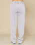 Light gray sweatpants on a beige background