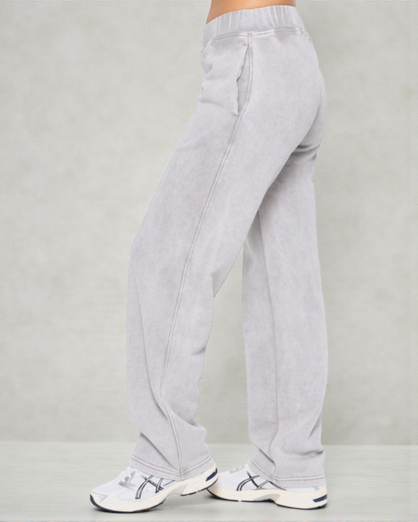 Light gray sweatpants worn by a person on a plain background