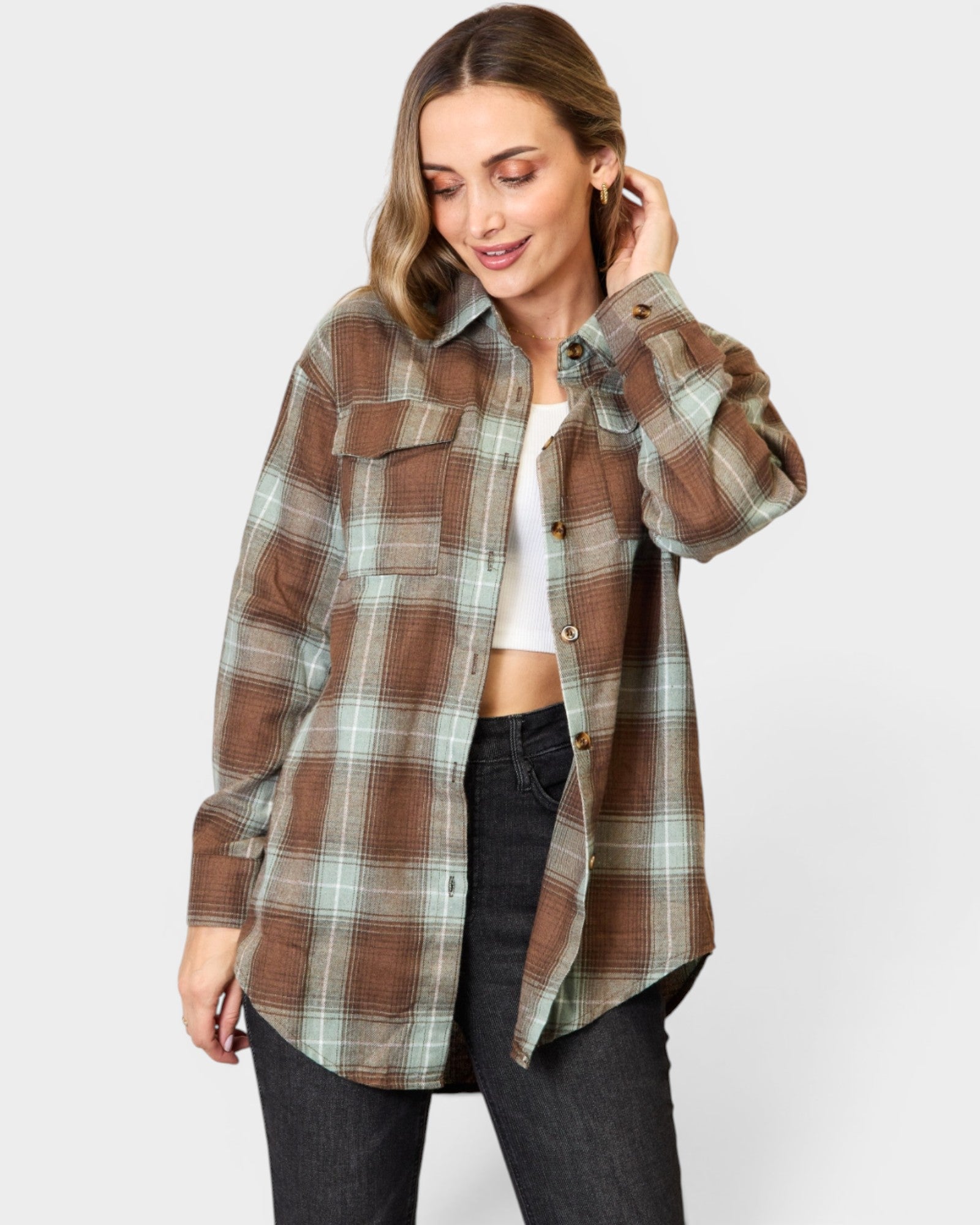 Woman wearing a plaid shirt on a white background