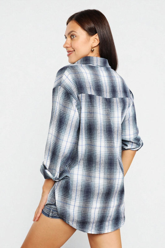 Woman wearing a plaid shirt on a white background