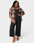 Woman wearing a plaid shirt over a black outfit on a white background