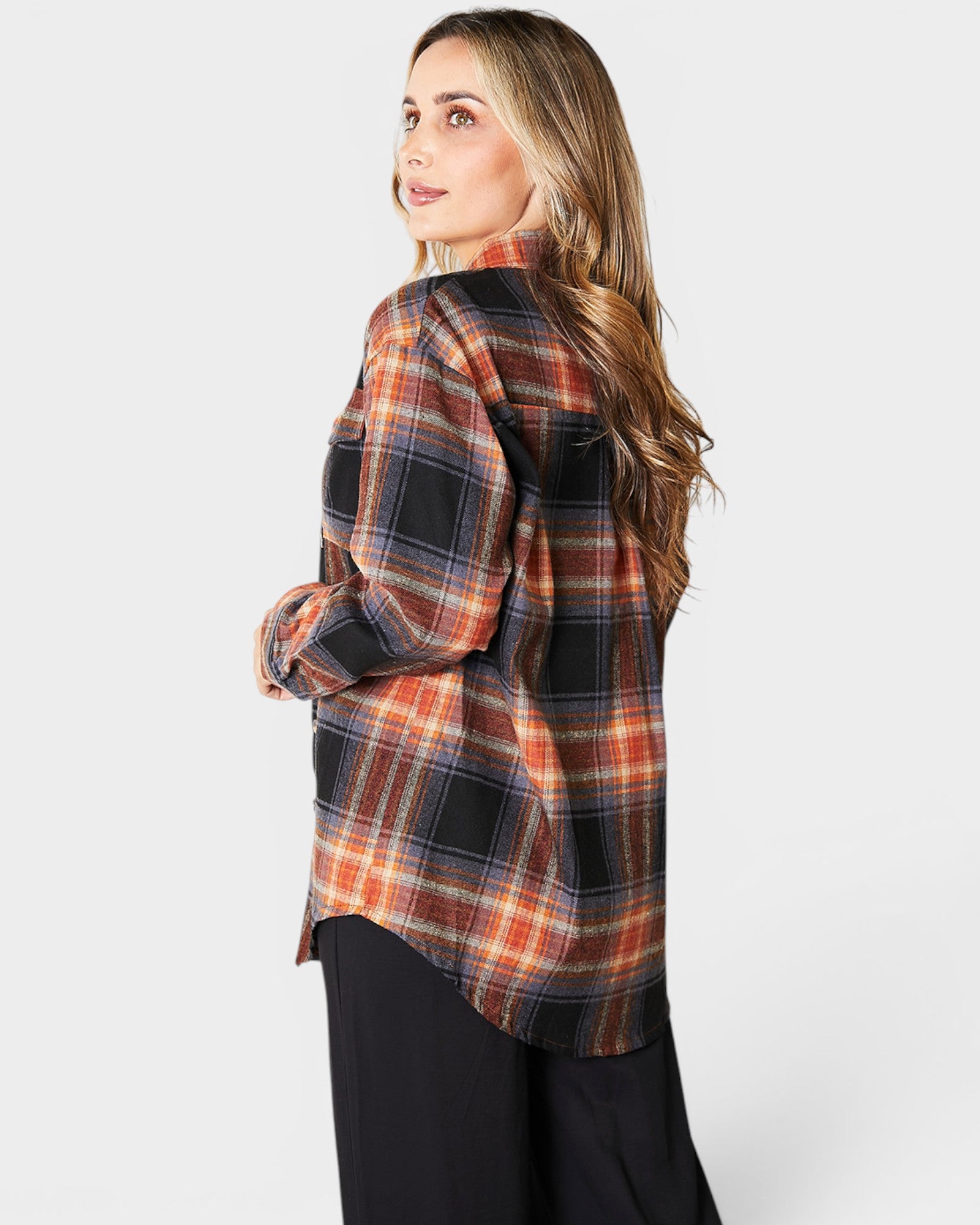 Woman wearing a plaid shirt with a white background