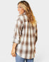 Woman wearing a plaid shirt on a white background