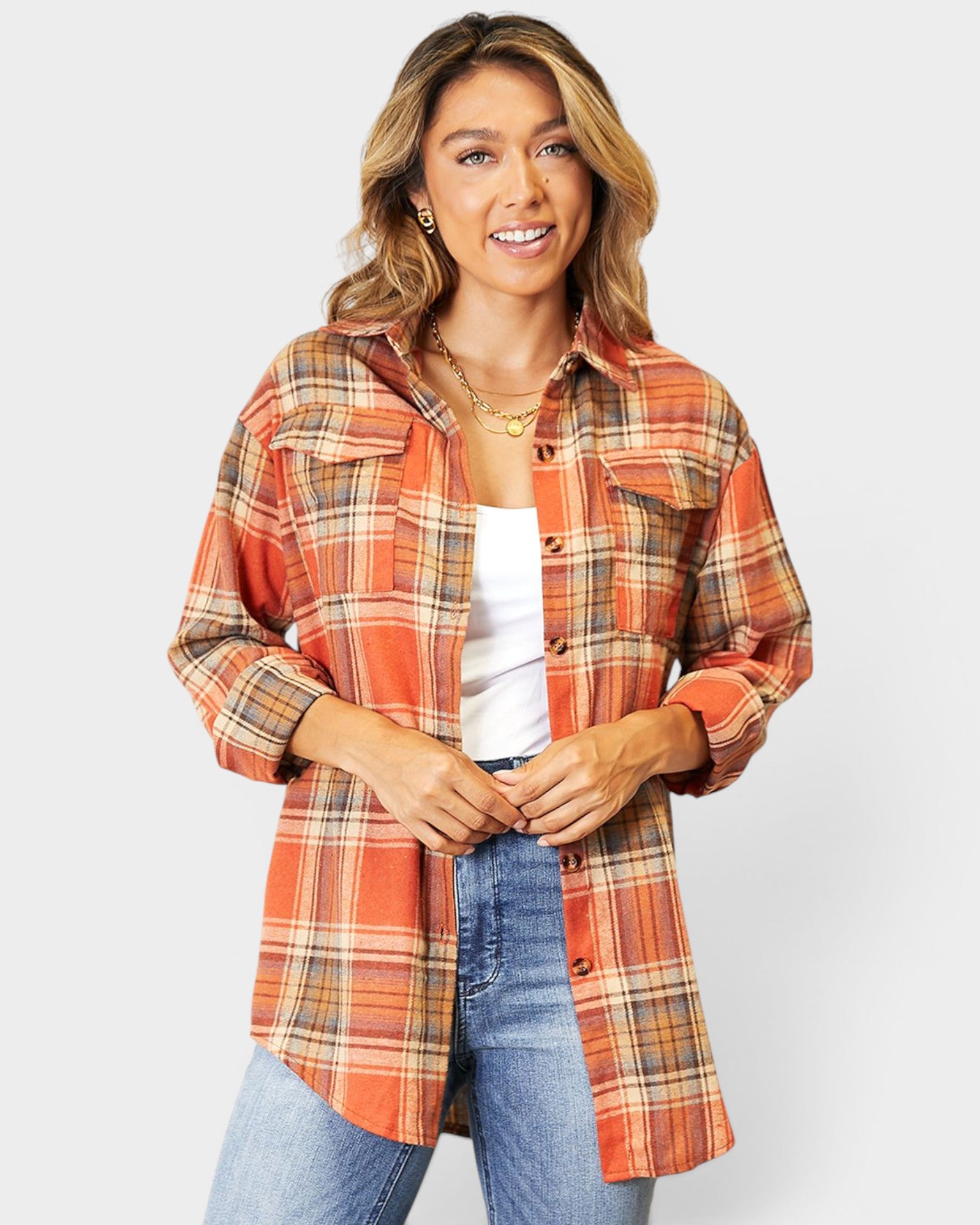 Woman wearing a plaid shirt with a white background