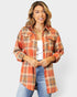 Woman wearing a plaid shirt with a white background