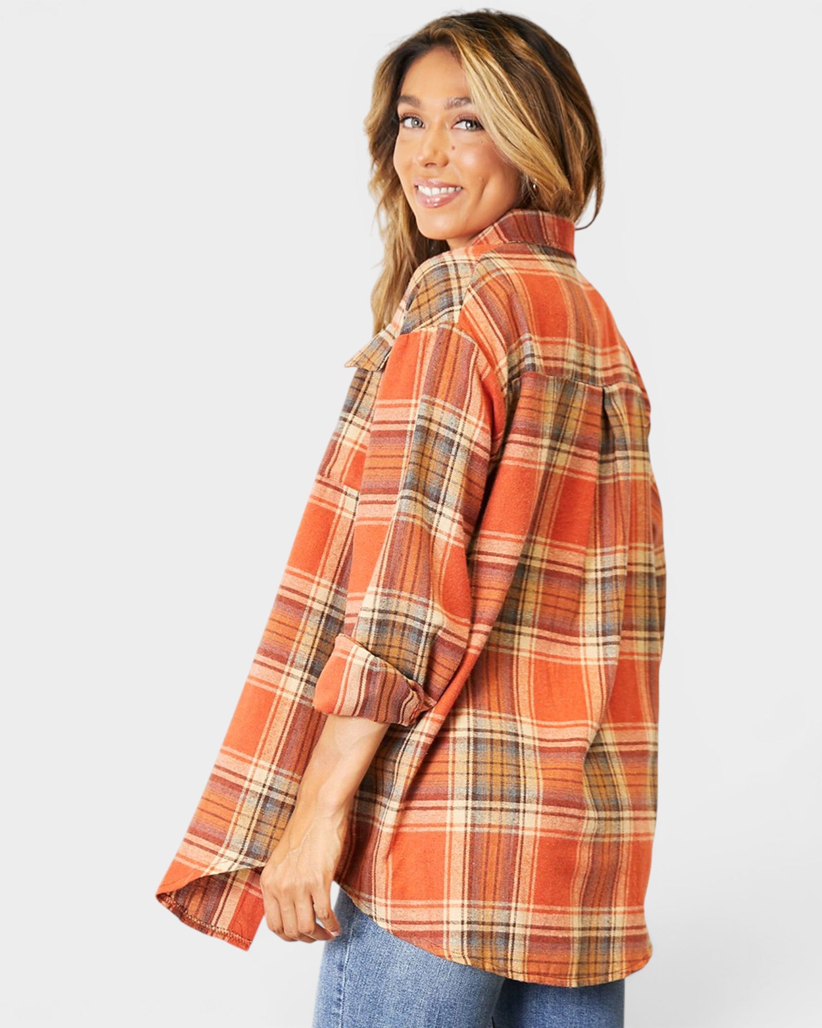 Woman wearing a plaid shirt with a white background
