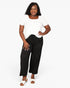 A woman modeling a white short-sleeve top and black wide-leg cropped pants against a plain white studio background.