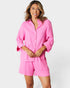 Woman wearing a pink outfit on a white background