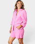 Woman wearing a pink outfit on a white background