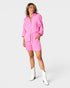 Woman wearing a pink outfit on a white background