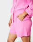 Person wearing a pink pajama set on a white background