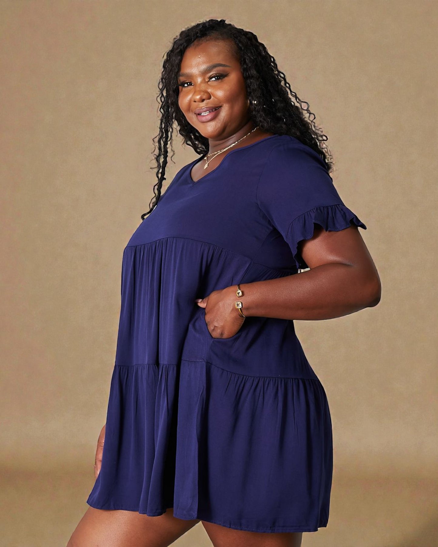 Woman wearing a blue dress against a beige background