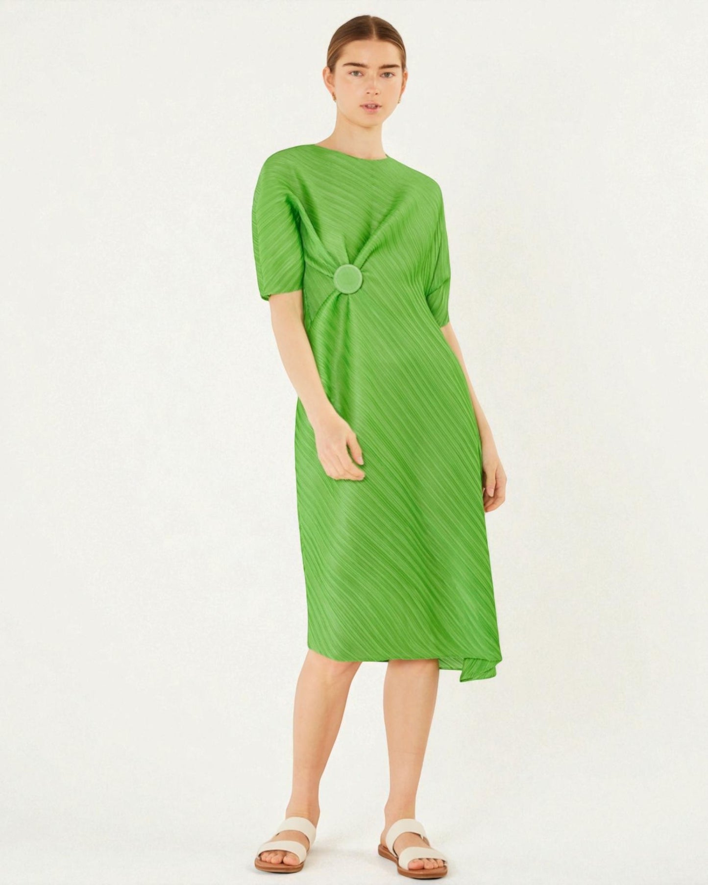 Woman wearing a green dress on a white background
