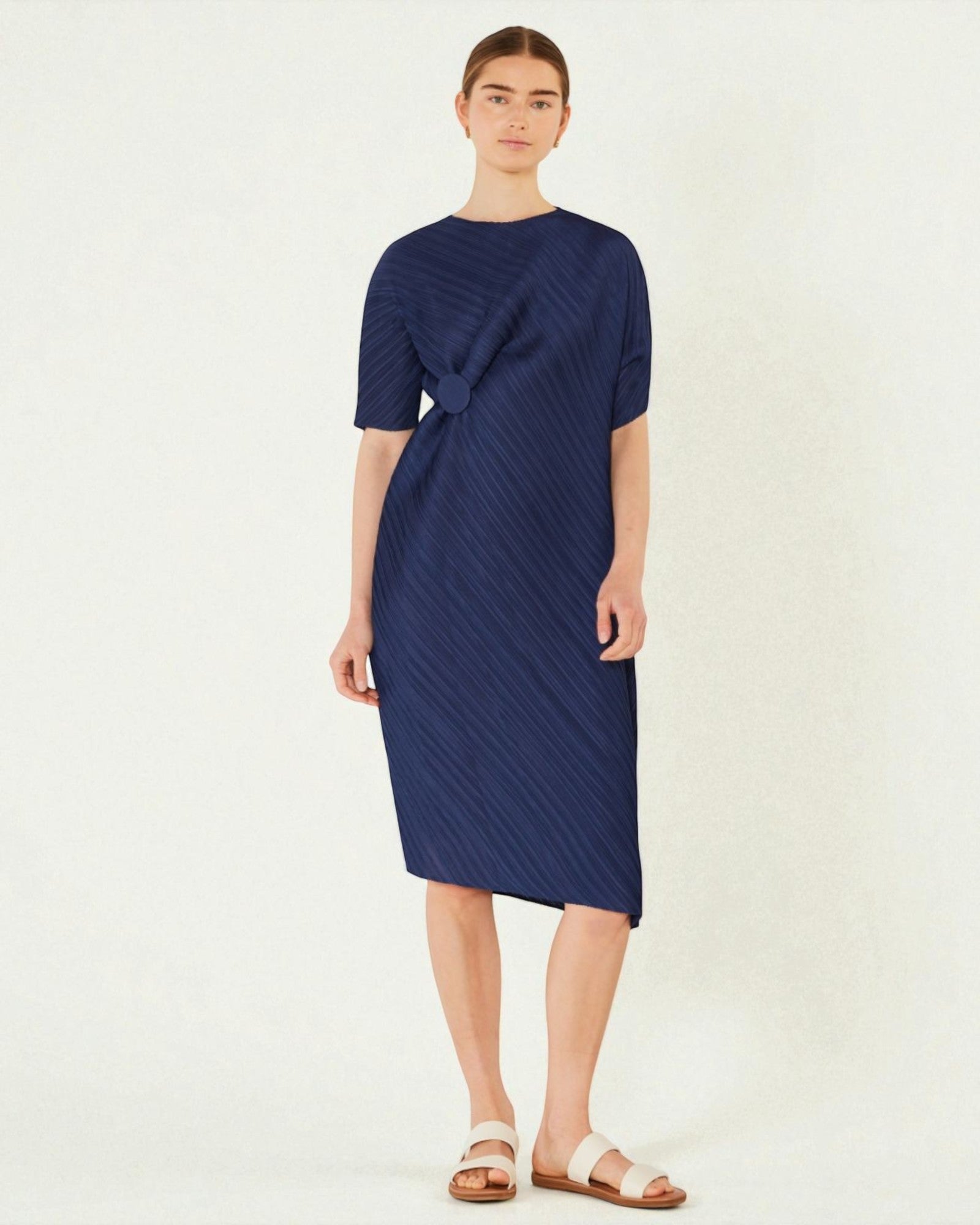 Woman wearing a navy blue dress on a white background