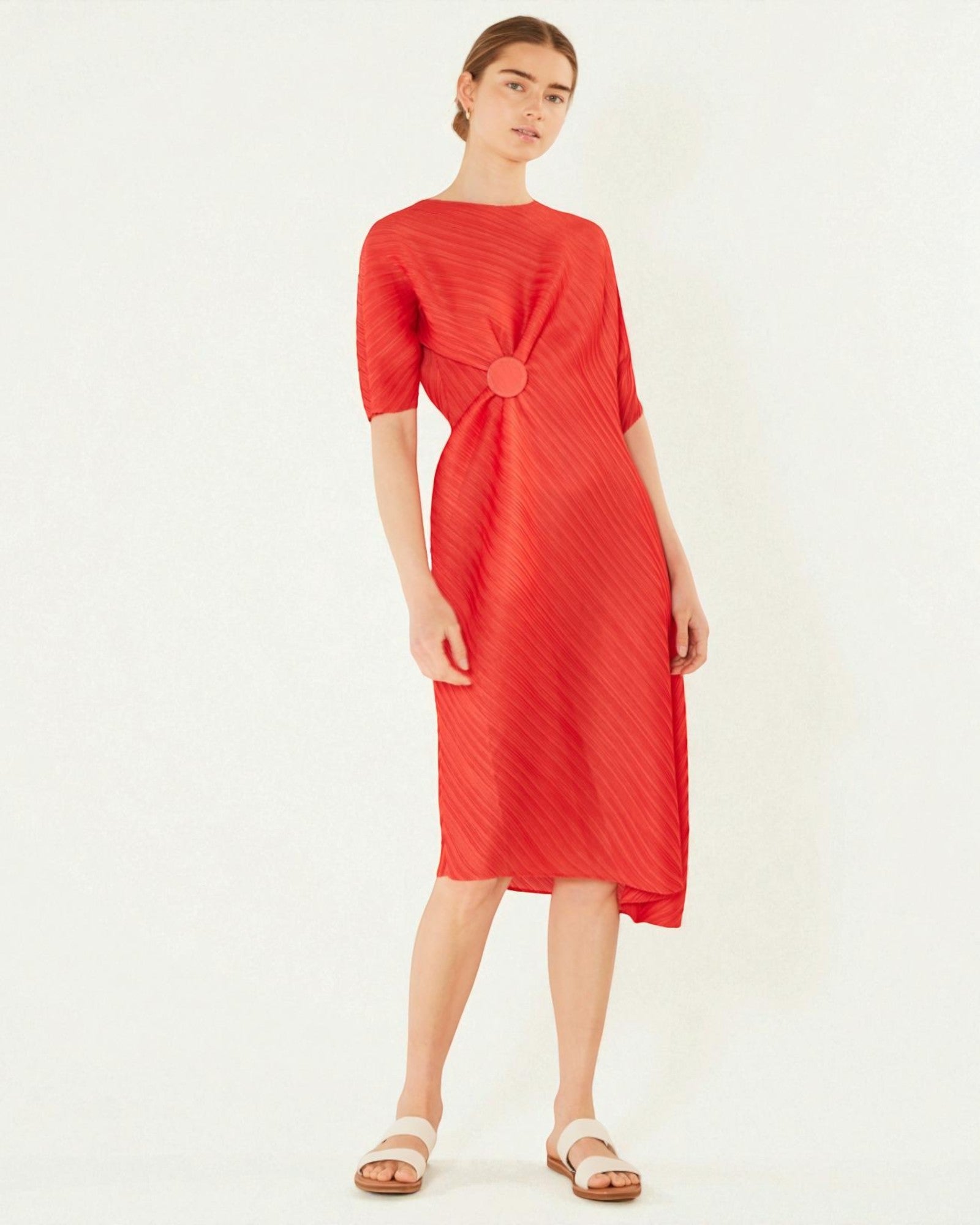 Woman wearing a red dress on a white background